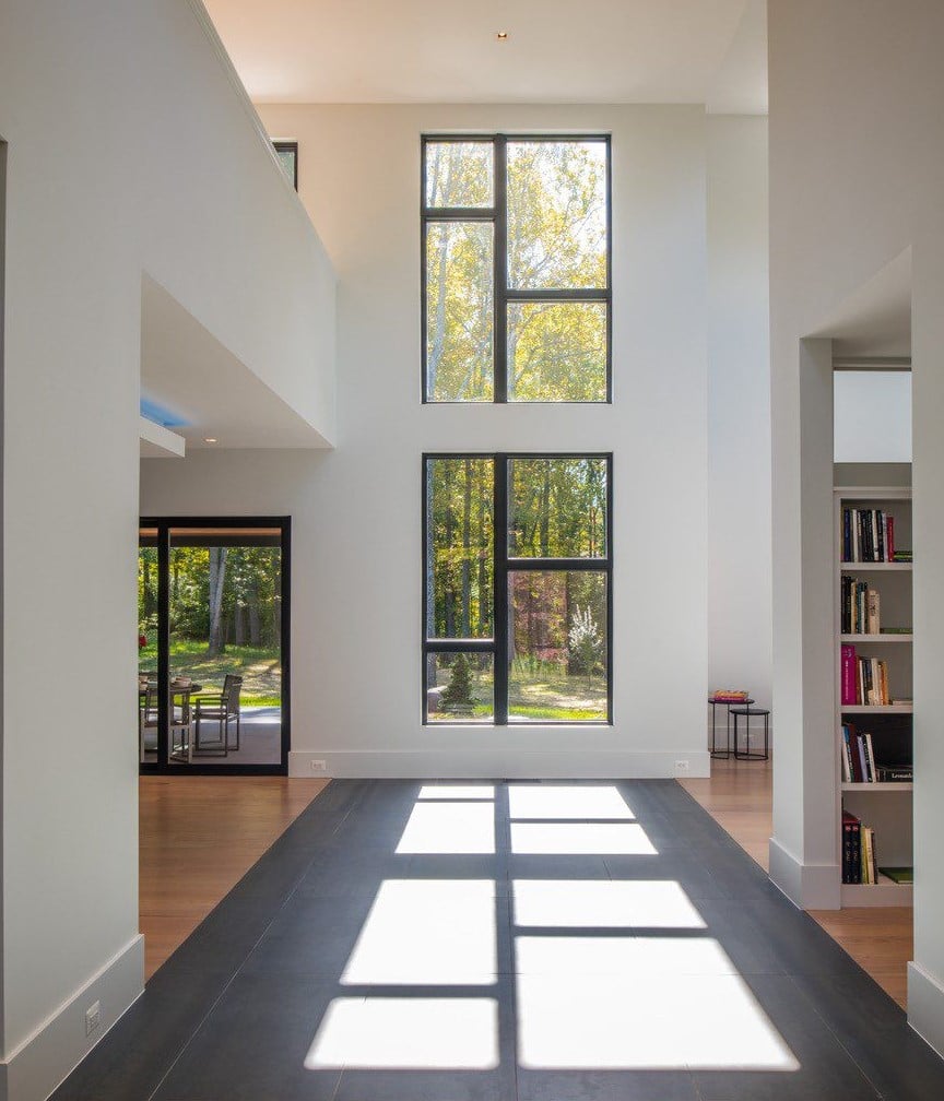 Image of modern home interior featuring large windows and shadows coming inside