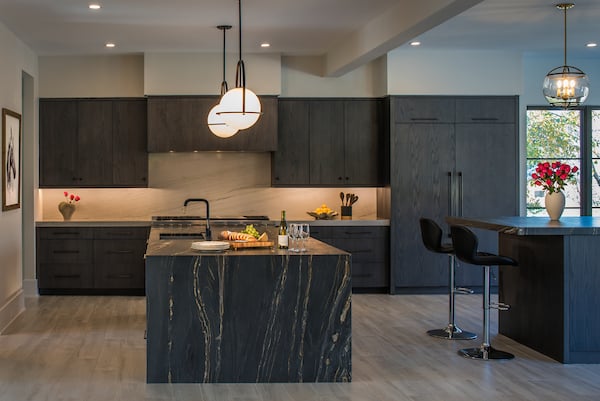 modern style kitchen with dark cabinets and black countertop